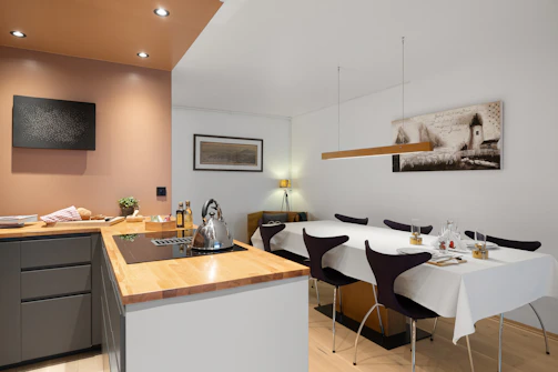 A kitchen with a table and chairs and a sink