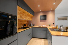 A kitchen with a sink, stove, and oven