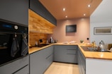 A kitchen with a sink, stove, and oven