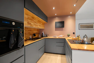 A kitchen with a sink, stove, and oven