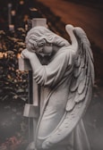 A statue of an angel holding a cross