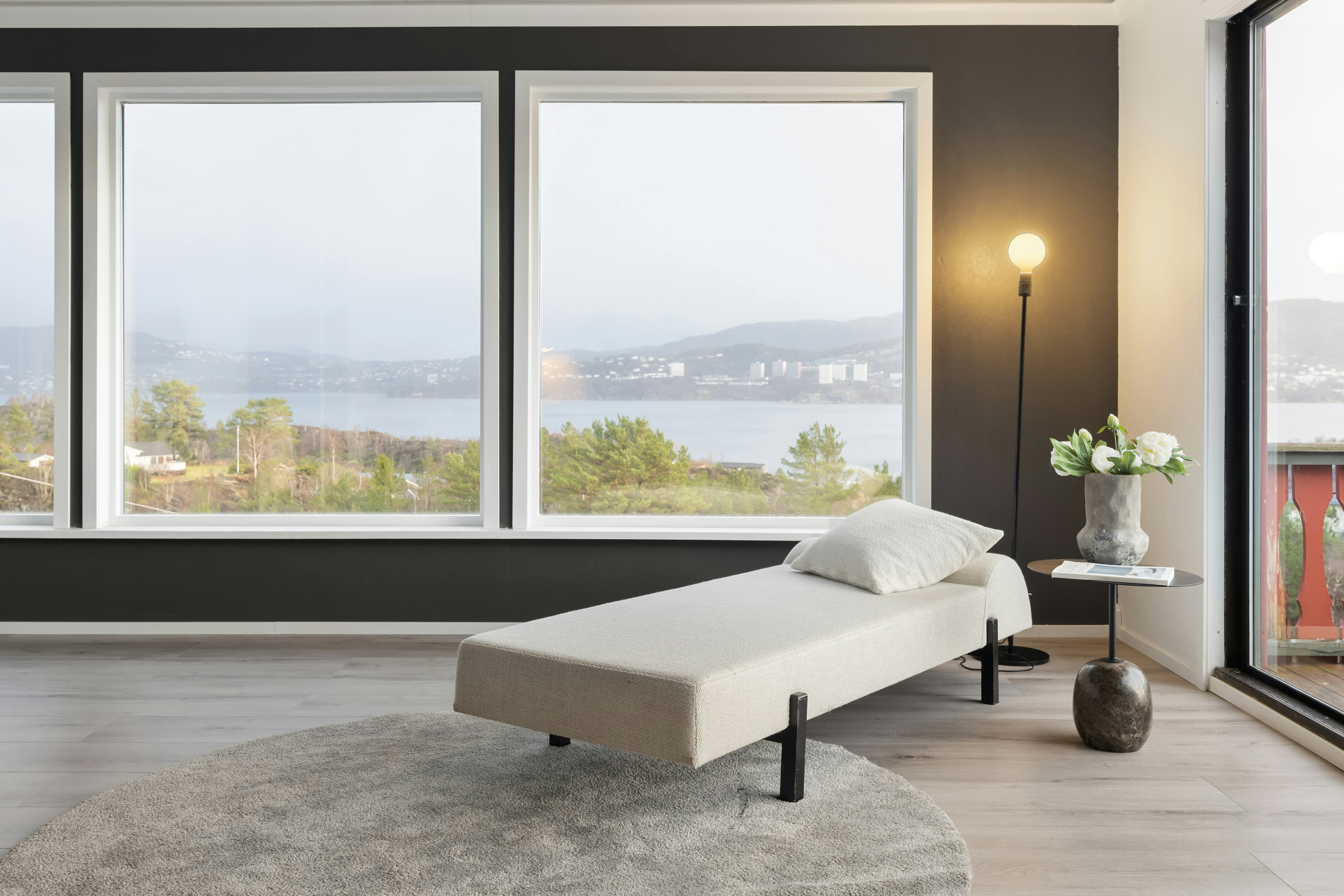 A living room with large windows and a white couch