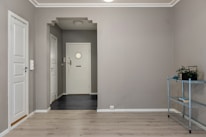 An empty room with a shelf and a door