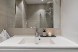 A bathroom with a sink and a mirror