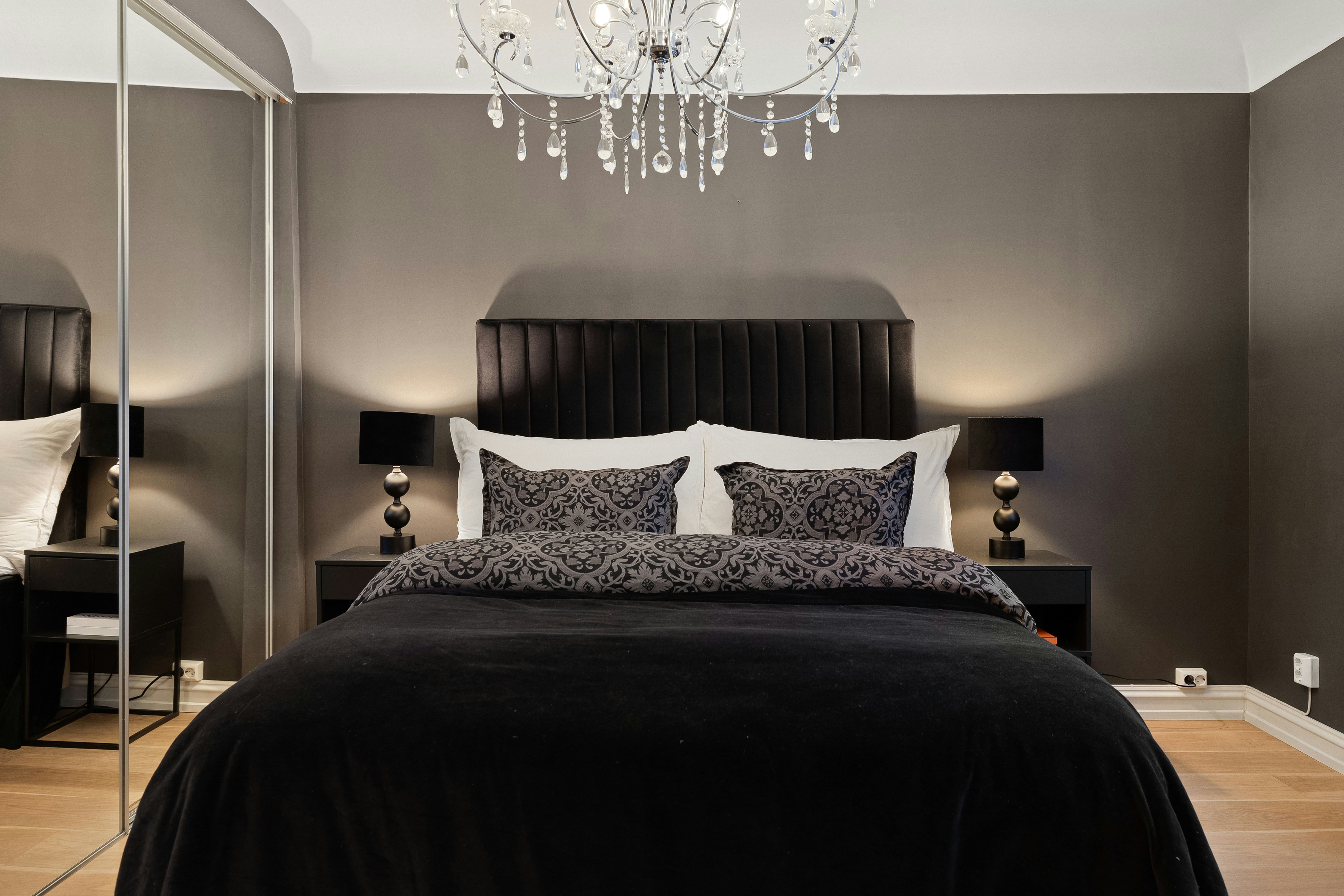 A luxurious bedroom interior with a comfortable mattress, warm lighting, and soft blankets, evoking a cozy winter atmosphere.