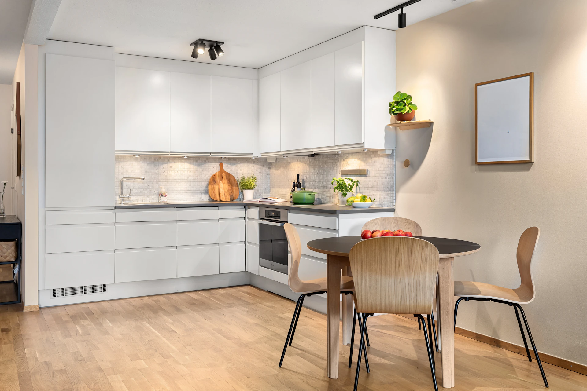 A kitchen with a table and chairs in it