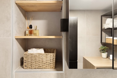 A bathroom with a sink, mirror and shelves