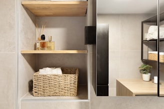 A bathroom with a sink, mirror and shelves