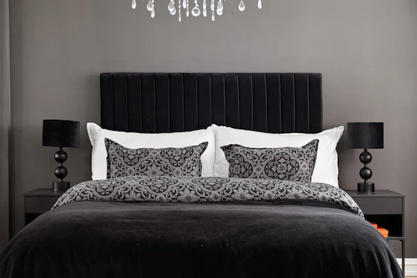A black and white bedroom with a chandelier