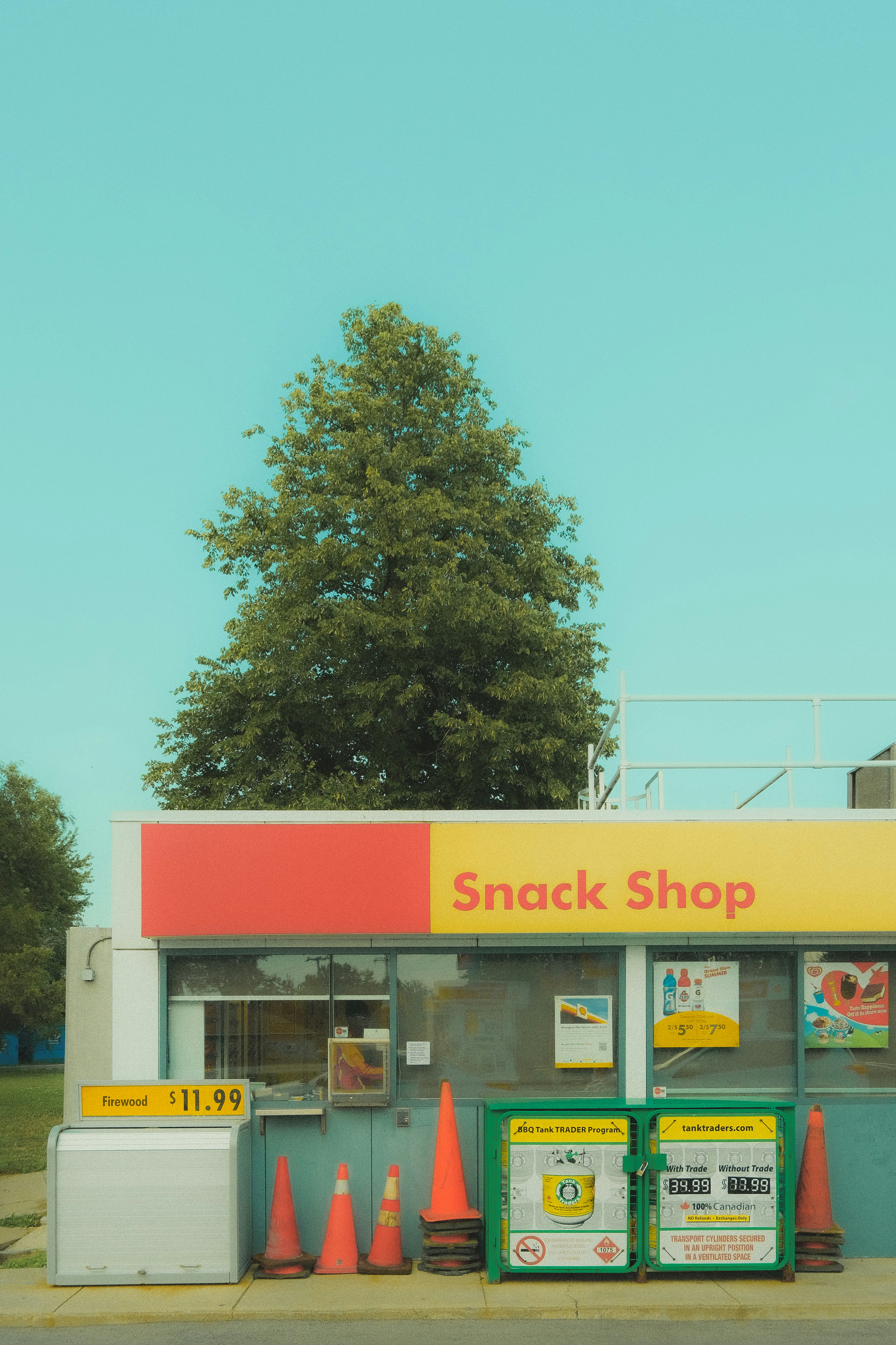 A snack shop with cones on the side of the road