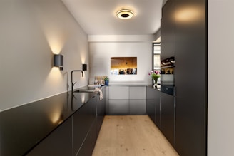 A long hallway with a wooden floor and white walls