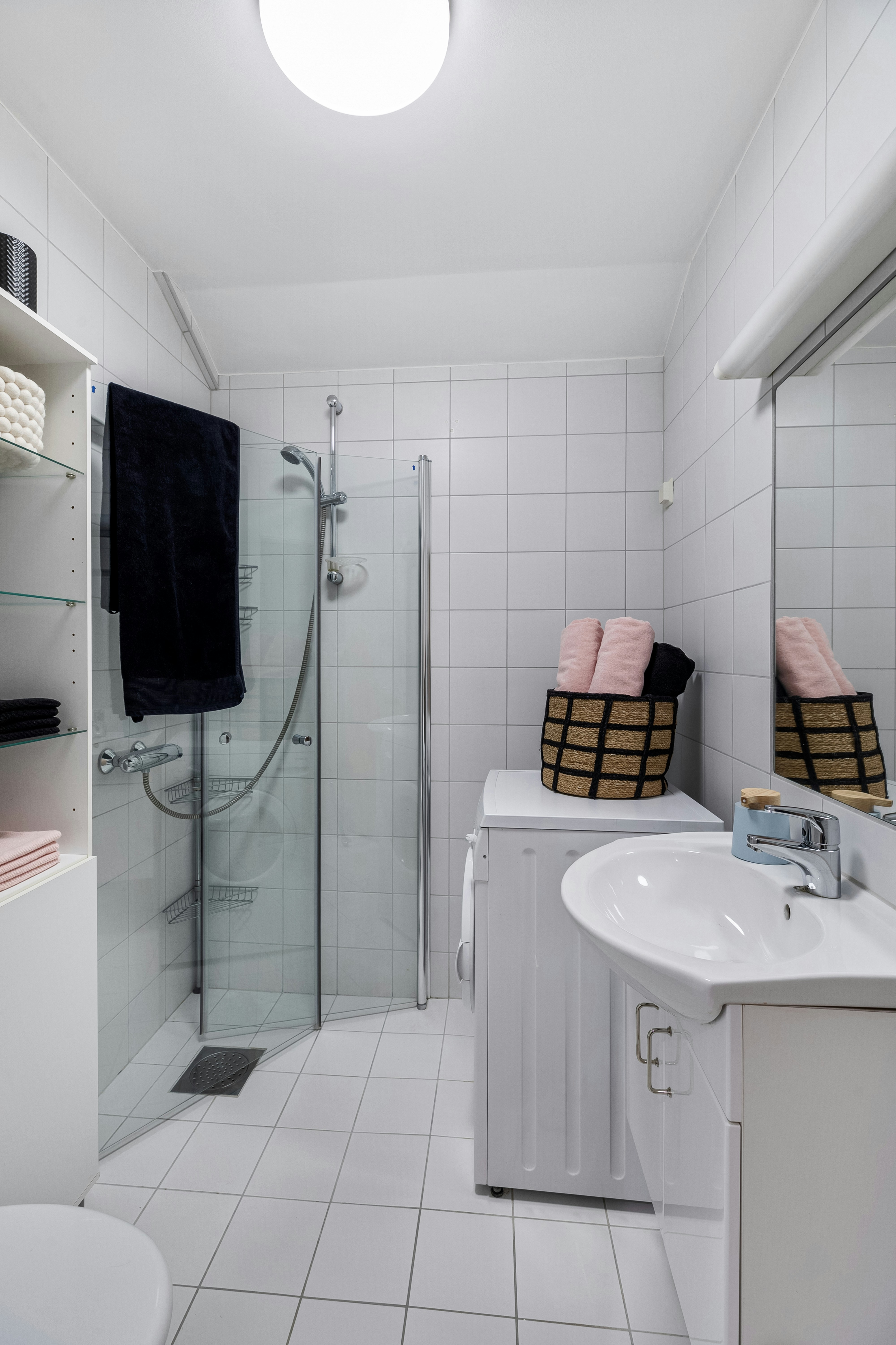 A bathroom with a sink, toilet, and shower