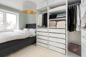 A bedroom with a bed and a closet