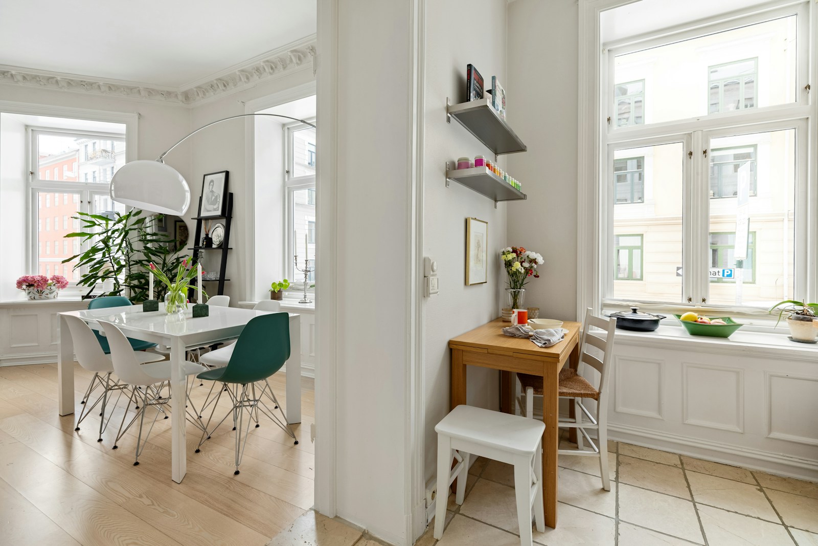 small dining nook with wooden table and chairs by apartment window