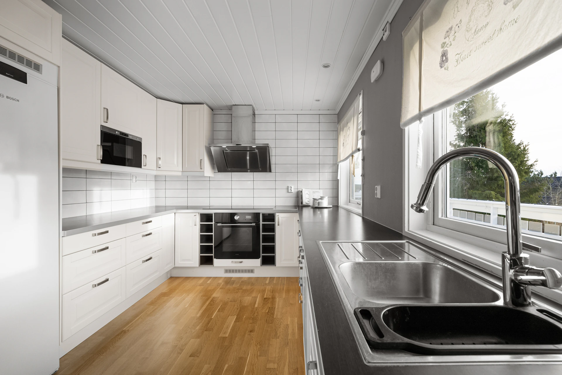 A kitchen with a sink and a refrigerator