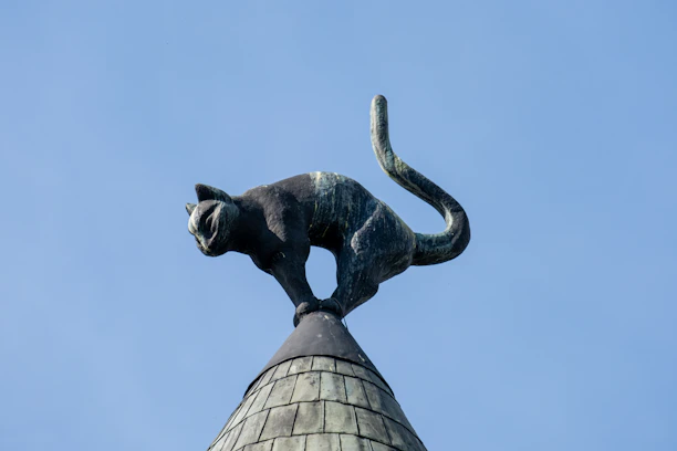 A statue of a cat on top of a building