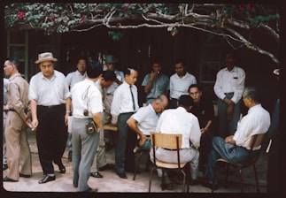A group of men standing around each other