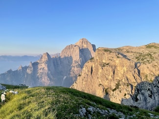 A view of a mountain range from the top of a hill