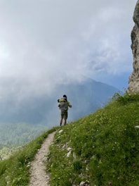 A man hiking up a hill with a backpack