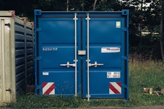 A couple of blue containers sitting next to each other