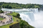 A group of people standing in front of a waterfall