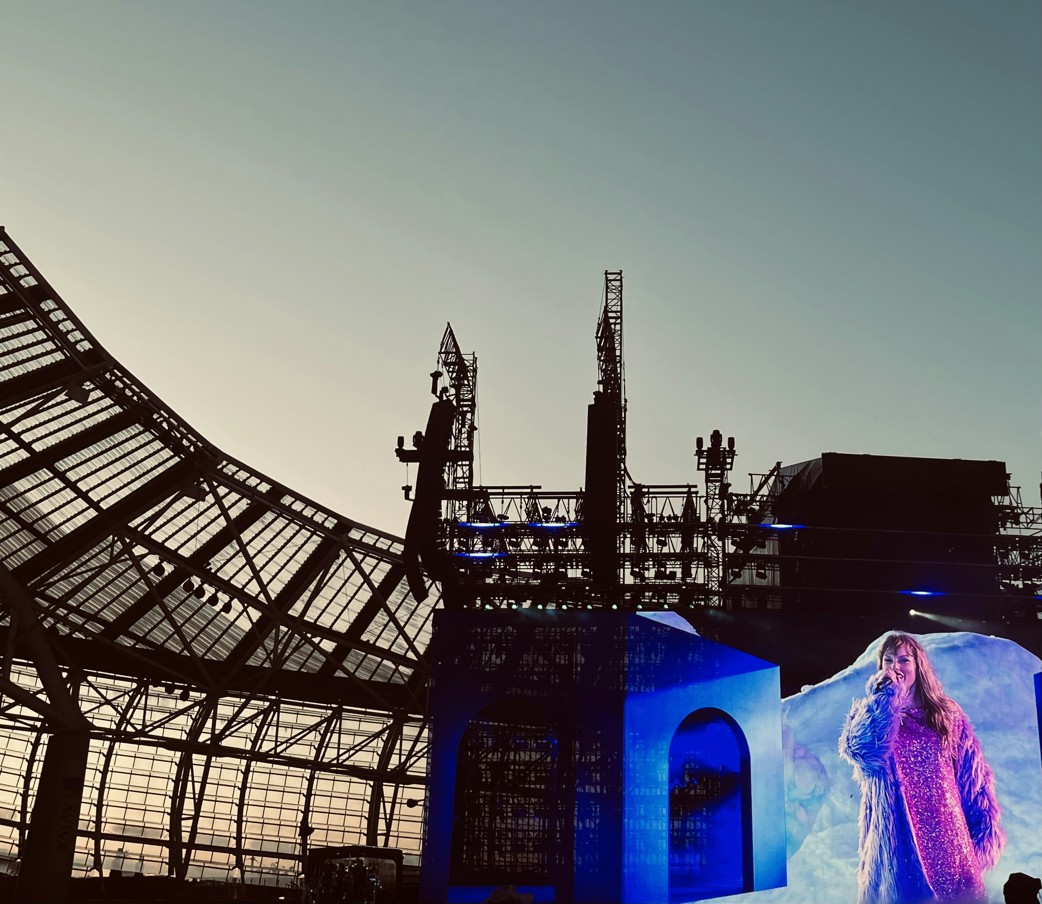 A woman standing on a stage in front of a building