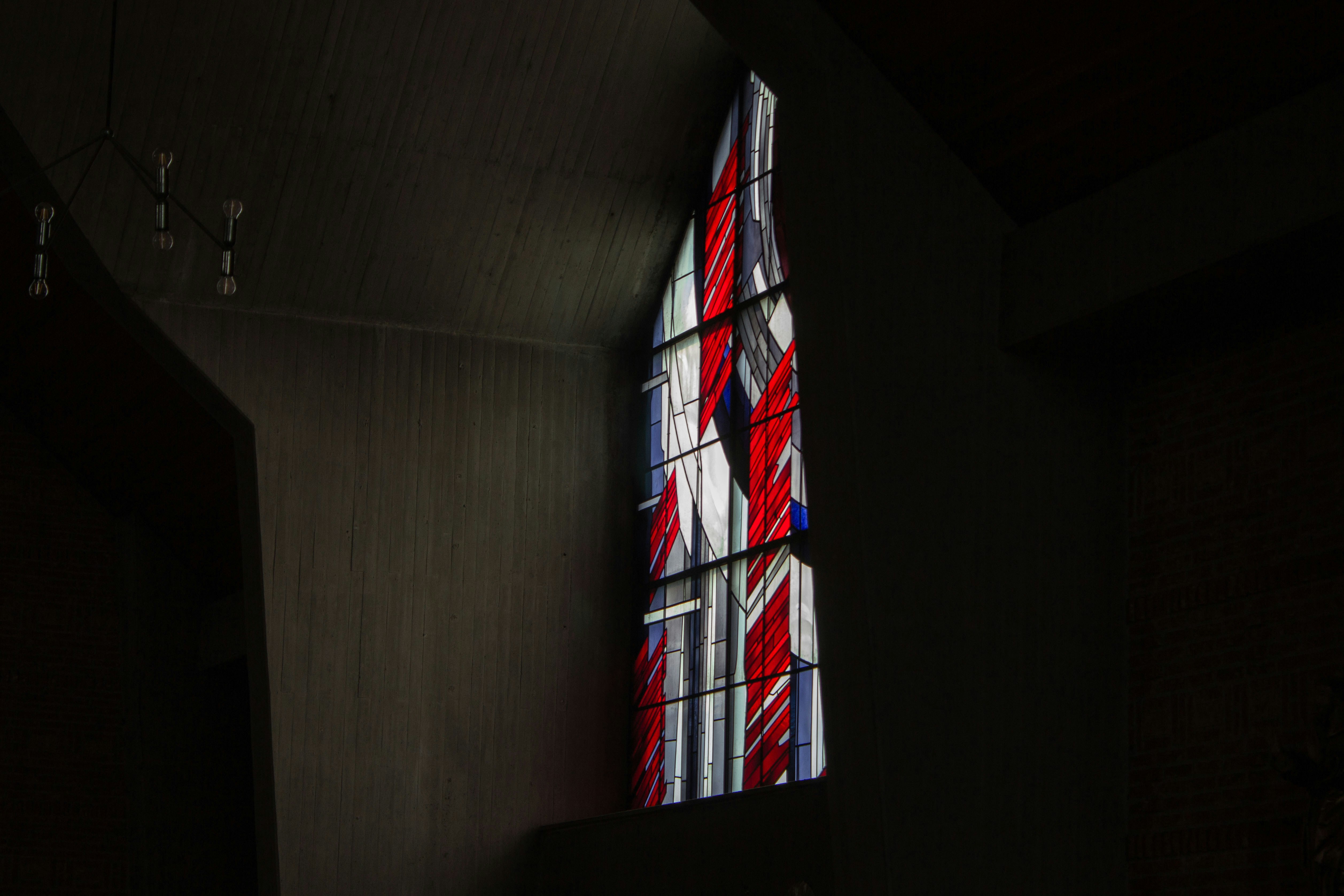 A stained glass window in a dark room