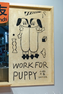 A picture of two dogs on a wooden frame