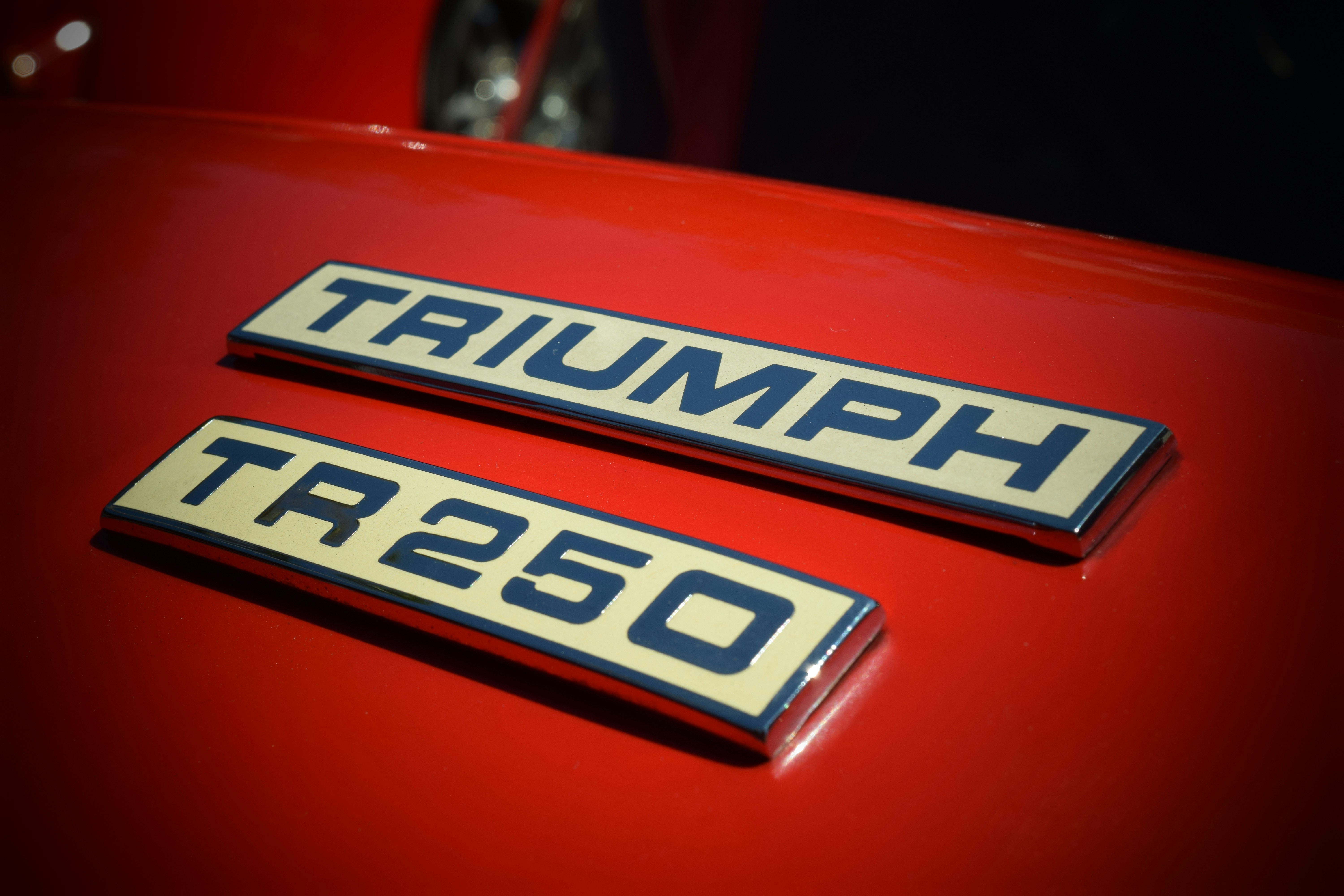 A close up of the emblem on a red car