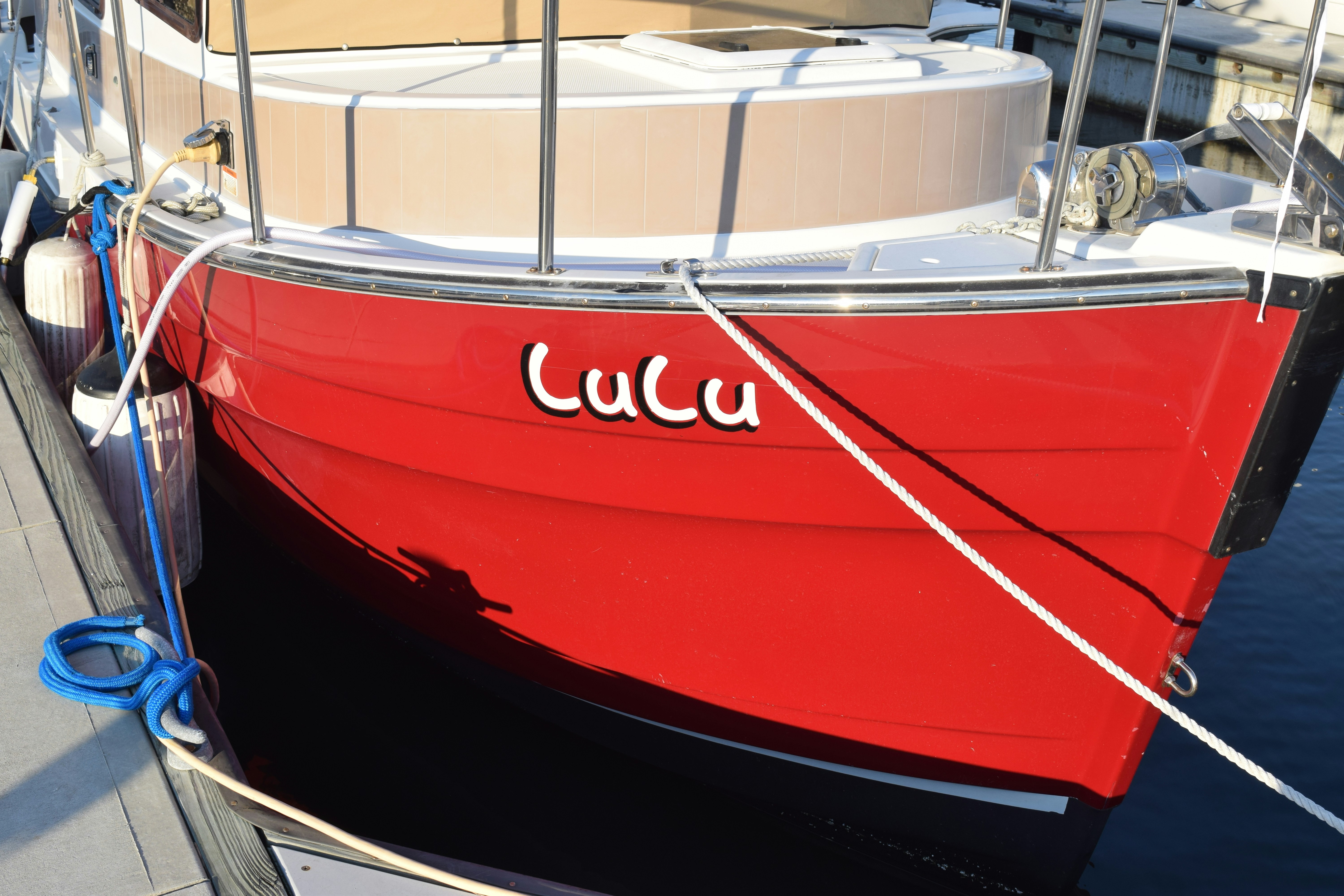 A red and white boat docked at a dock