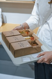 A woman holding a tray of food in her hands