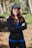 A woman wearing a black jacket and a blue shirt