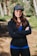 A woman wearing a black jacket and a blue shirt