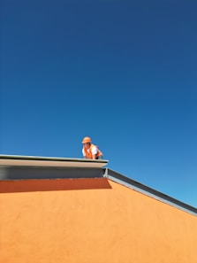 A man standing on top of a roof