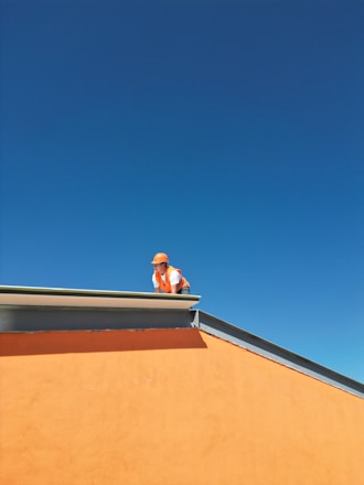 A man standing on top of a roof