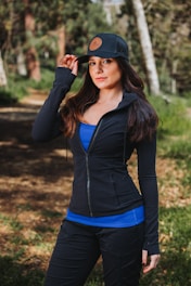 A woman in a black jacket and blue top