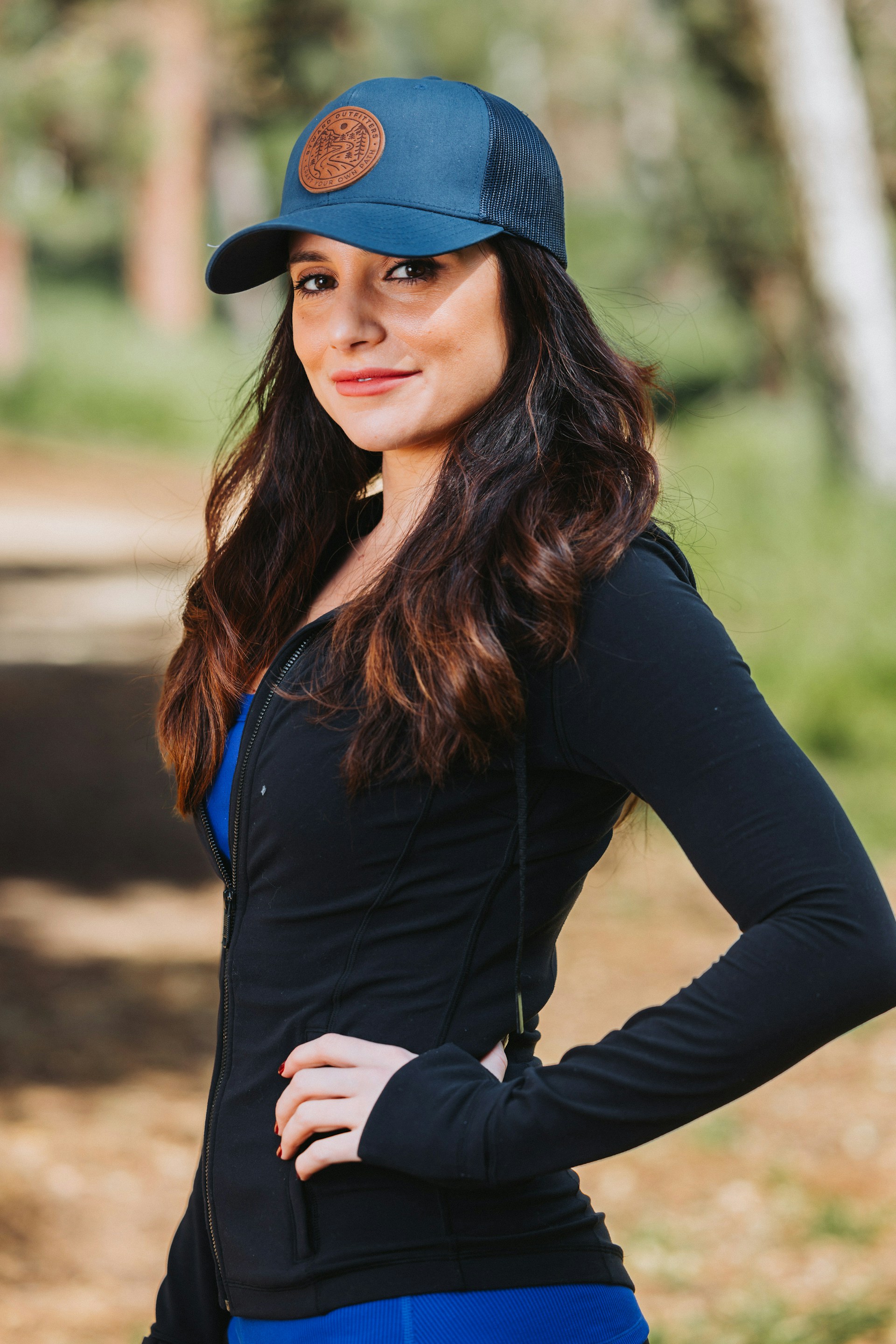 A woman wearing a blue hat and black shirt