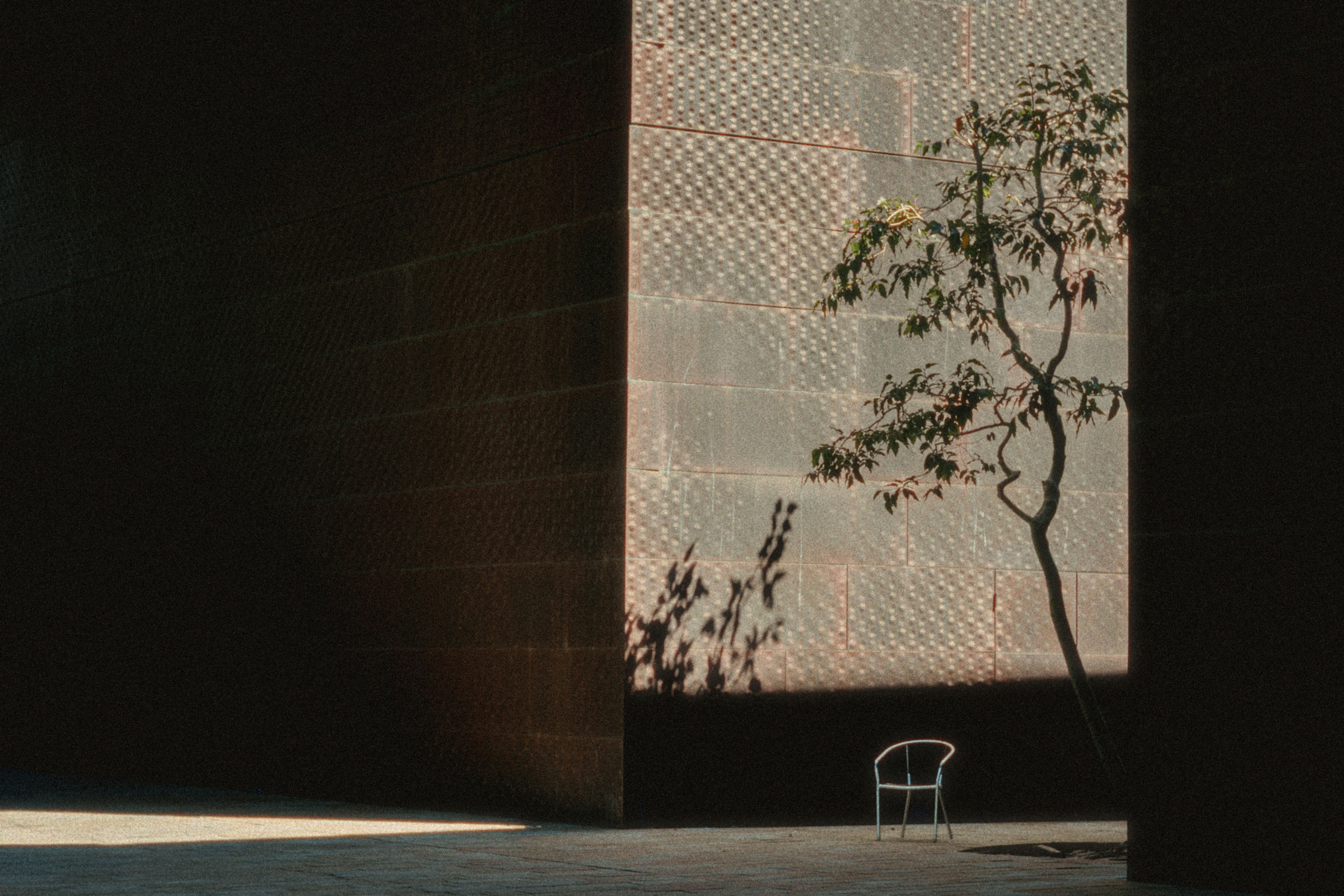 A white chair sitting in front of a tall building