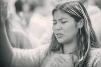 A woman holding her hands up in the air