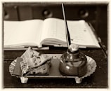 An open book and a pen on a tray
