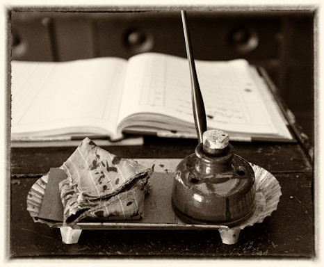 An open book and a pen on a tray