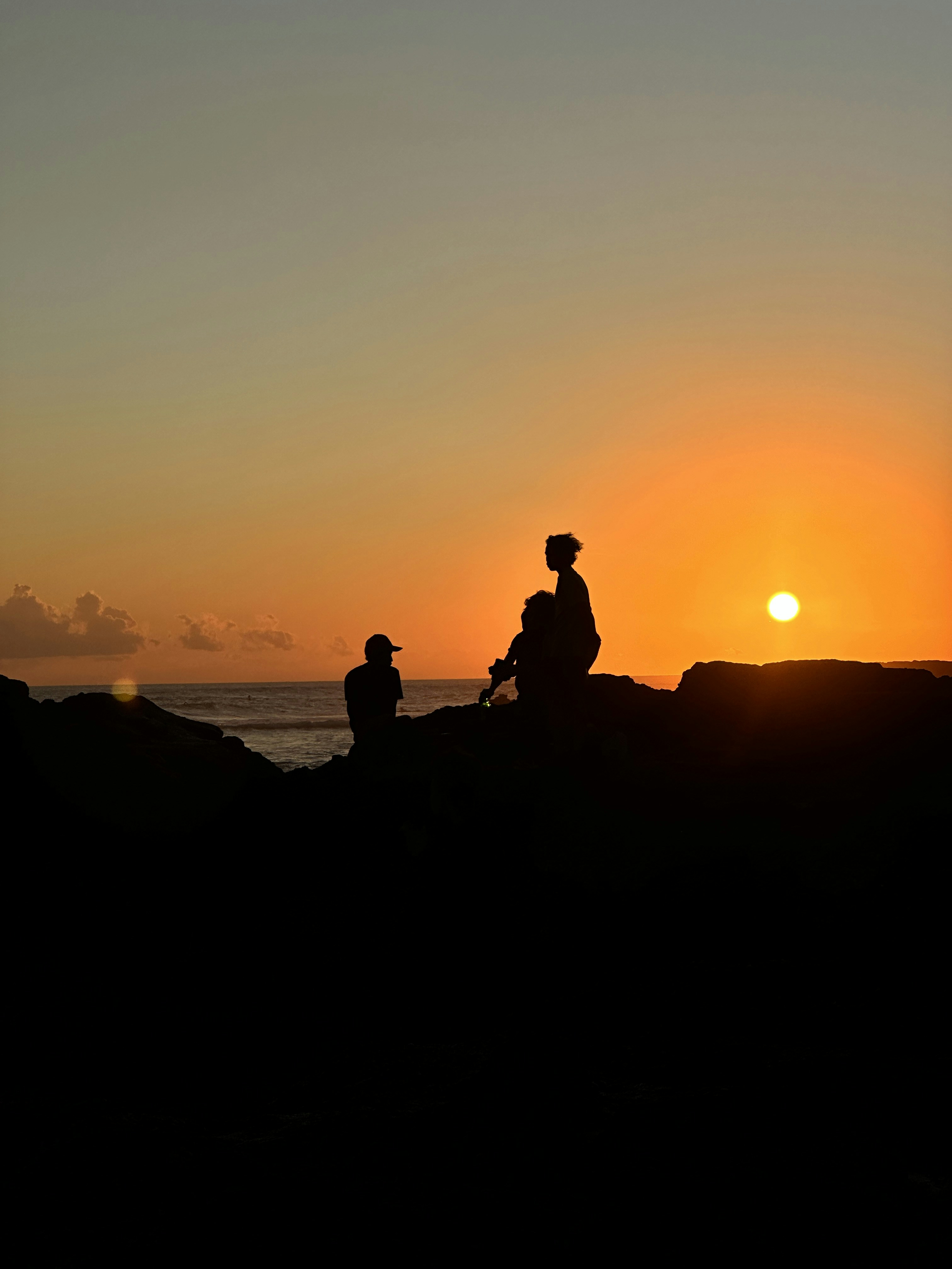 Family enjoying a sunset at a Maui beach