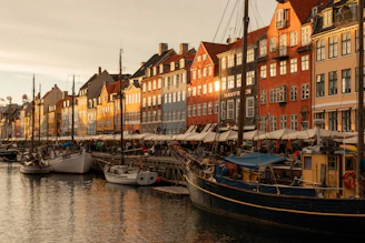 A harbor filled with lots of boats next to tall buildings
