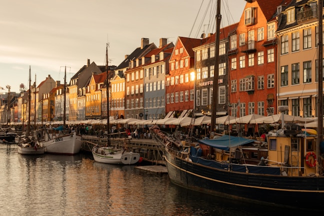 A harbor filled with lots of boats next to tall buildings