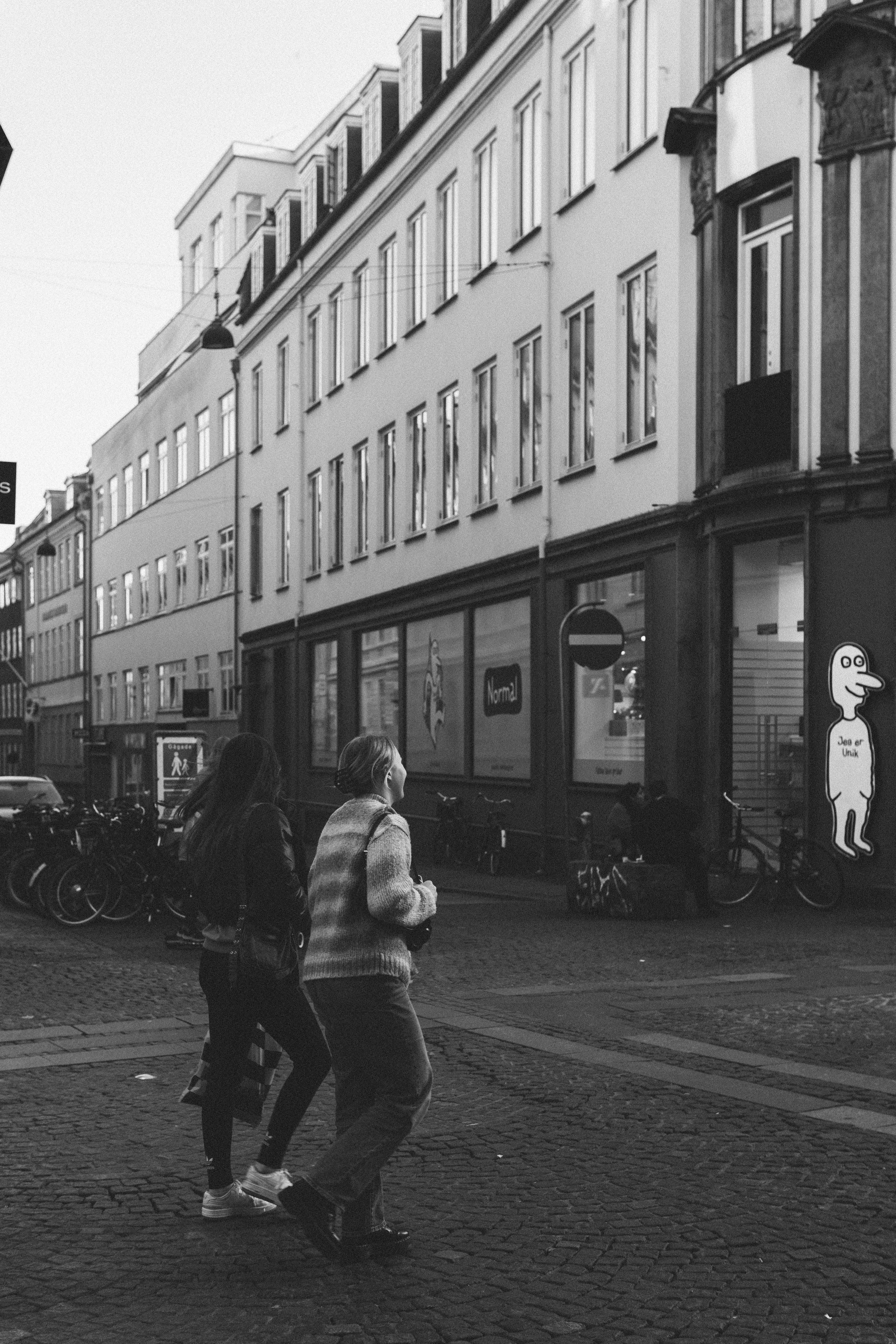 A couple of people that are standing in the street