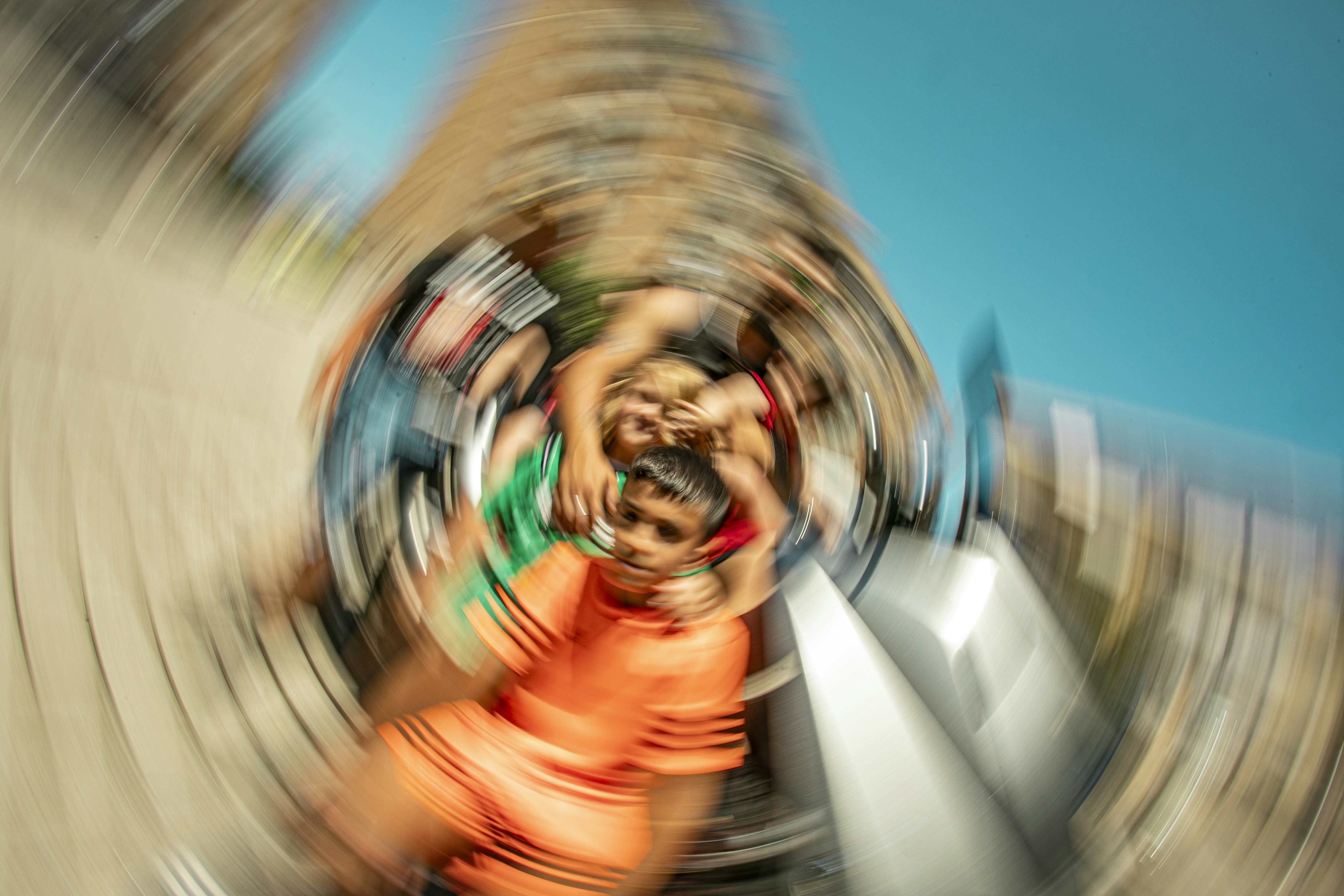 A blurry photo of a person riding a roller coaster