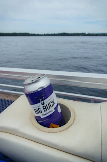 A can of beer sitting on the back of a boat
