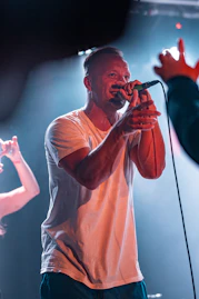 A man singing into a microphone on stage