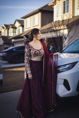 A woman standing next to a white car