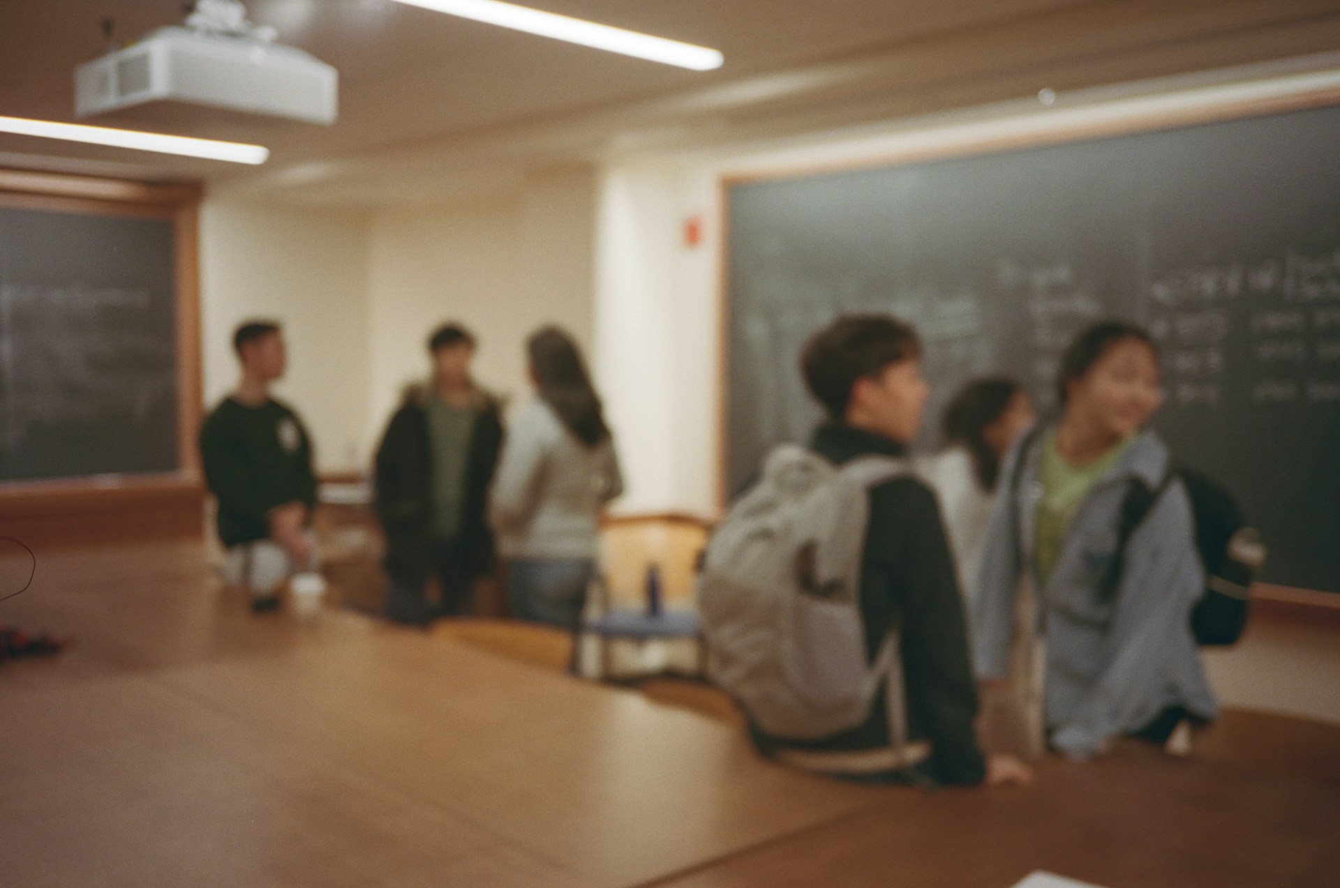 A group of people standing in front of a blackboard
